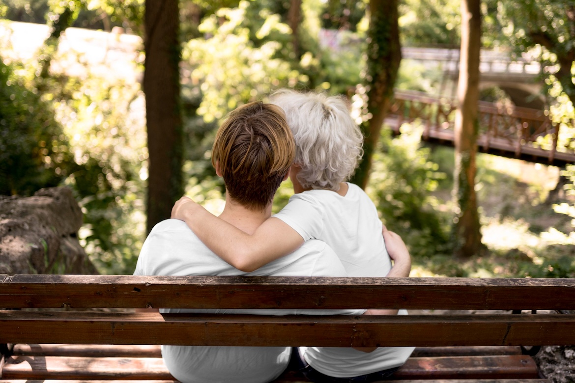 back-view-embraced-couple-admiring-park-view-from-bench.jpg